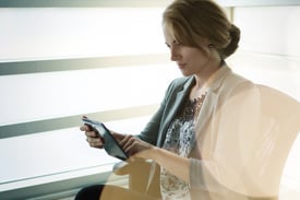 Filtered portrait of an executive business woman writing on a glass wall at sunset