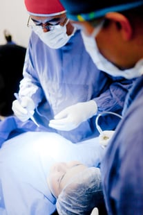 Group of surgeons operating on a patient