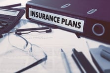 Insurance Plans - Ring Binder on Office Desktop with Office Supplies. Business Concept on Blurred Background. Toned Illustration.-May-06-2026-01-40-30-1996-PM