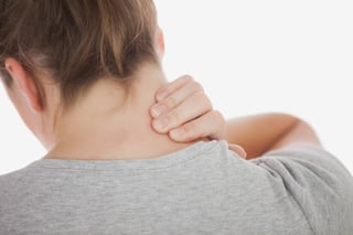 Close-up of woman suffering from neckache against white background.jpeg