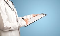 Female doctor holding notepad with blue background