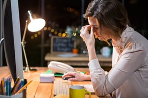 Stressed businesswoman sitting at her desk in the office-2