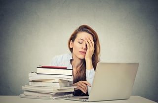 Too much work tired sleepy young woman sitting at her desk with books in front of laptop computer isolated grey wall office background. Busy schedule in college, workplace, sleep deprivation concept.jpeg