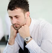 Stress and concern, businessman holding his head at office