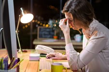 Stressed businesswoman sitting at her desk in the office-1