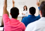Students in class asking questions to the teacher