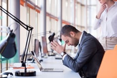 frustrated young business man working on laptop computer at office-1