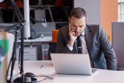 frustrated young business man working on laptop computer at office-2