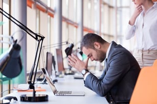 frustrated young business man working on laptop computer at office-3