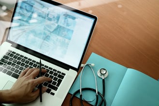 top view of Medicine doctor hand working with modern computer and smart phone on wooden desk as medical concept-1